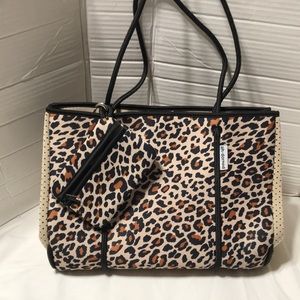 Ah-dorned non leather tote with pouch. NWOT